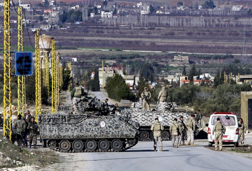 In this Saturday, Feb. 2, 2013, Lebanese army soldiers search civilians at a checkpoint at the entrance of Arsal, a Sunni Muslim town in eastern Lebanon near the Syrian border. Gunmen fired on a Lebanese government checkpoint near the Syrian border on Tuesday, May, 28, 2013 killing several soldiers, the state-run National News Agency said. The attack comes amid escalating tensions in Lebanon linked to Syria's conflict, in which rival Lebanese groups have taken sides. (AP Photo/Bilal Hussein)