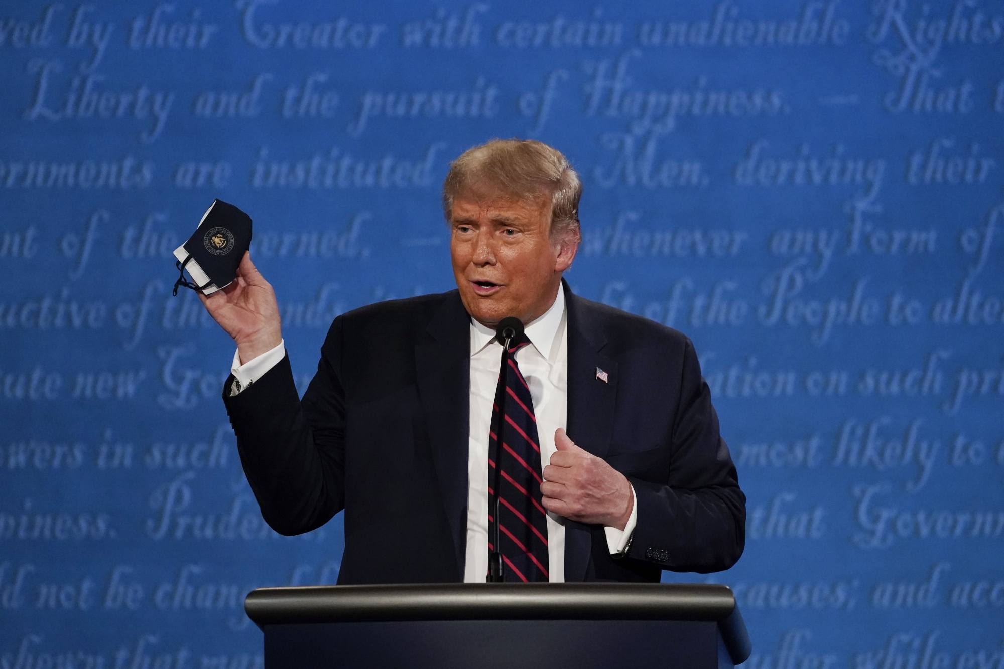 In this Sept. 29, 2020, file photo, President Donald Trump holds up his facemask during the first presidential debate at Case Western University and Cleveland Clinic, in Cleveland, Ohio. President Trump and first lady Melania Trump have tested positive for the coronavirus, the president tweeted early Friday. In this (AP Photo/Julio Cortez, File) Donald Trump ArcInfo