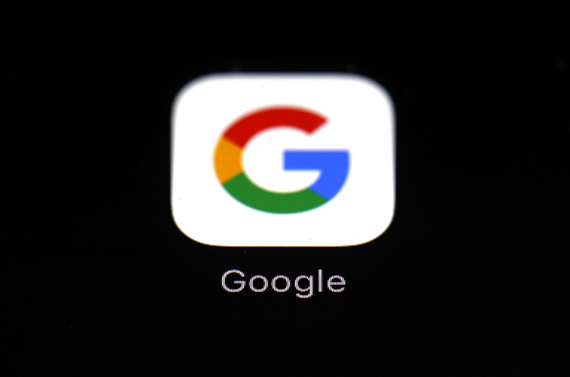 FILE - This March 19, 2018, file photo shows a Google app in Baltimore. Google will try to make a bigger splash in the smartphone market with a cheaper high-end model while it also aims to expand its presence on bigger screens with a new TV service. The products unveiled Wednesday, Sept. 30, 2020, focus on two areas where Google has struggled to make significant inroads. (AP Photo/Patrick Semansky, File) ArcInfo