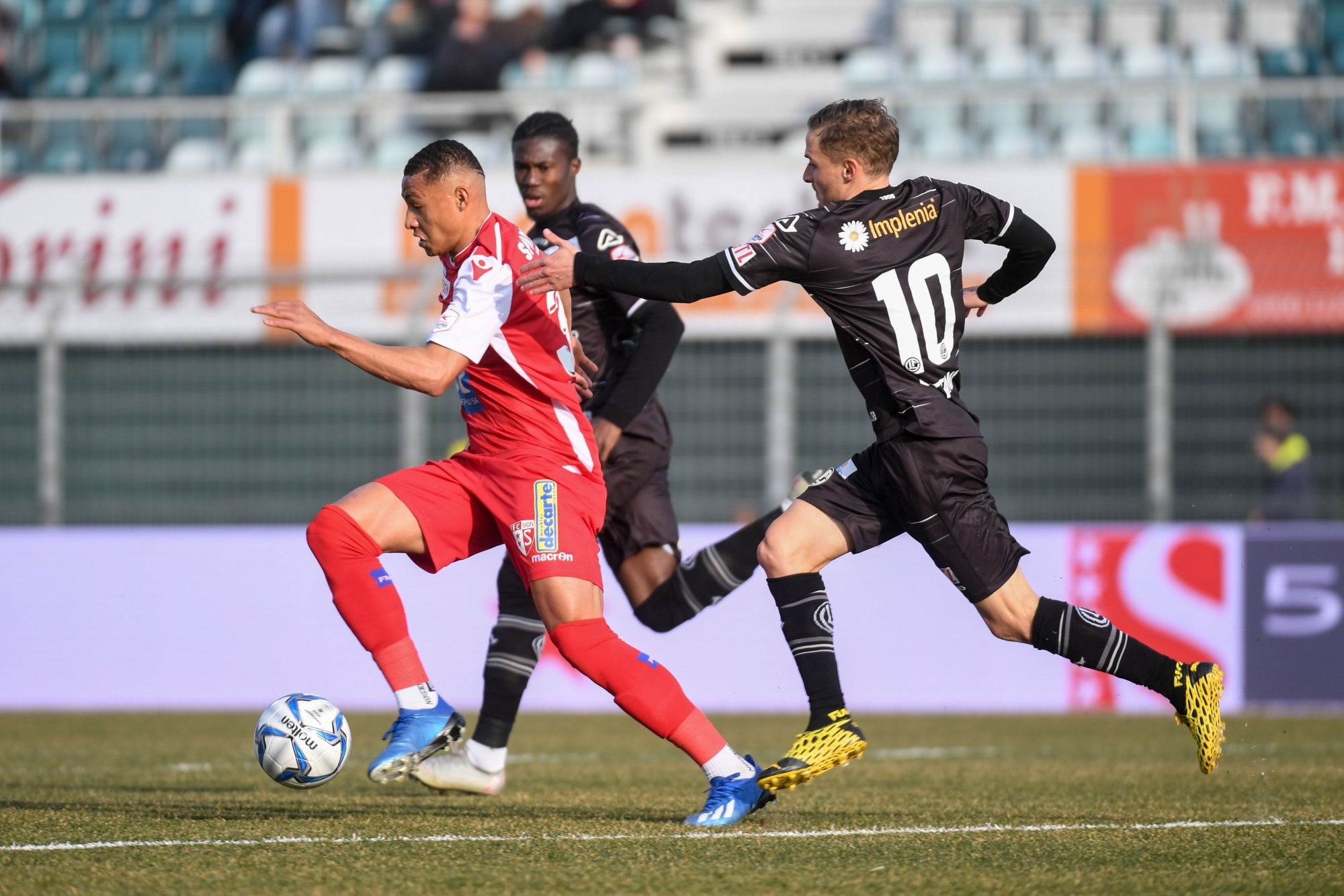 Patrick Luan tente d'échapper à Eloge Yao et à Mattia Bottani lors du dernier match entre le FC Sion et le FC Lugano au Cornaredo le 23 février.