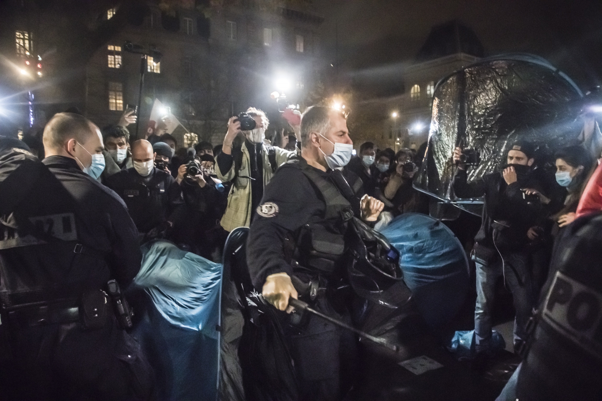 epaselect epa08838441 French police officers evacuate migrants with their tents after hundreds of migrants and refugees evacuated from a makeshift migrant camp in Saint-Denis on 17 November installed tents in Republic Square with the support of associations and organisations; in Paris, France, 23 November 2020 (issued 24 November 2020).  EPA/CHRISTOPHE PETIT TESSON ArcInfo