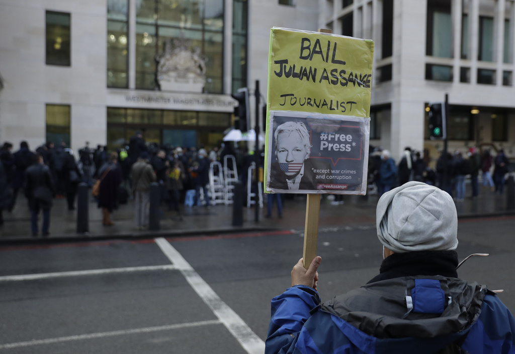 A Julian Assange supporter holds up a placard outside Westminster Magistrates Court as his bail hearing is held at the court in London, Wednesday, Jan. 6, 2021. On Monday Judge Vanessa Baraitser ruled that Julian Assange cannot be extradited to the US. because of concerns about his mental health. Assange had been charged under the US's 1917 Espionage Act for "unlawfully obtaining and disclosing classified documents related to the national defence". Assange remains in custody, the US. has 14 days to appeal against the ruling.(AP Photo/Matt Dunham)