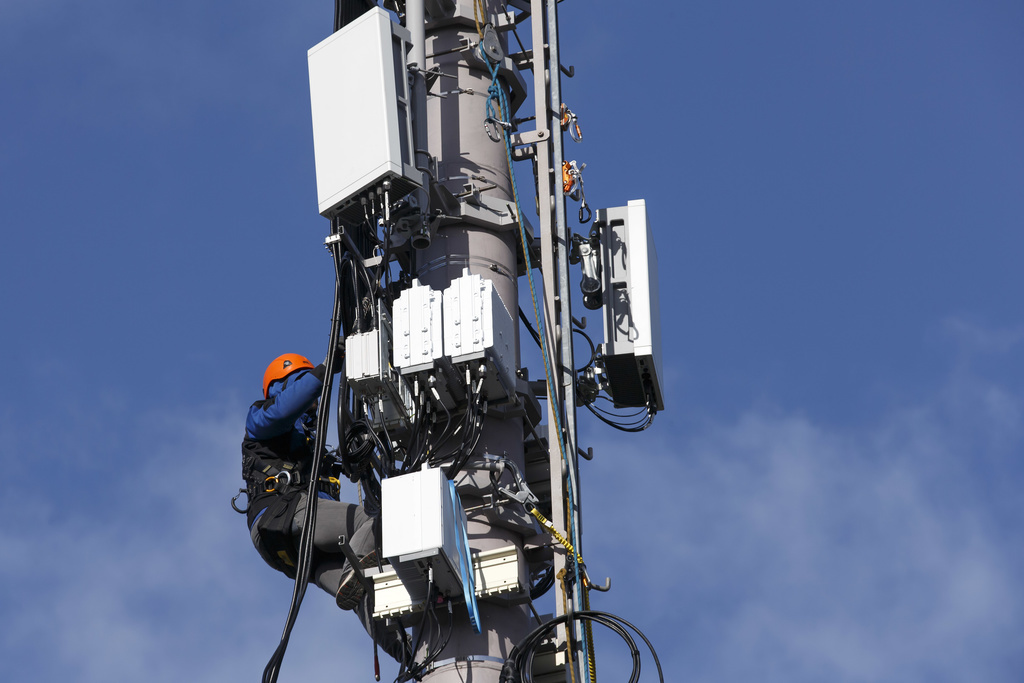 Un technicien câble des antennes 5G pour la téléphonie mobile, à Genève.
