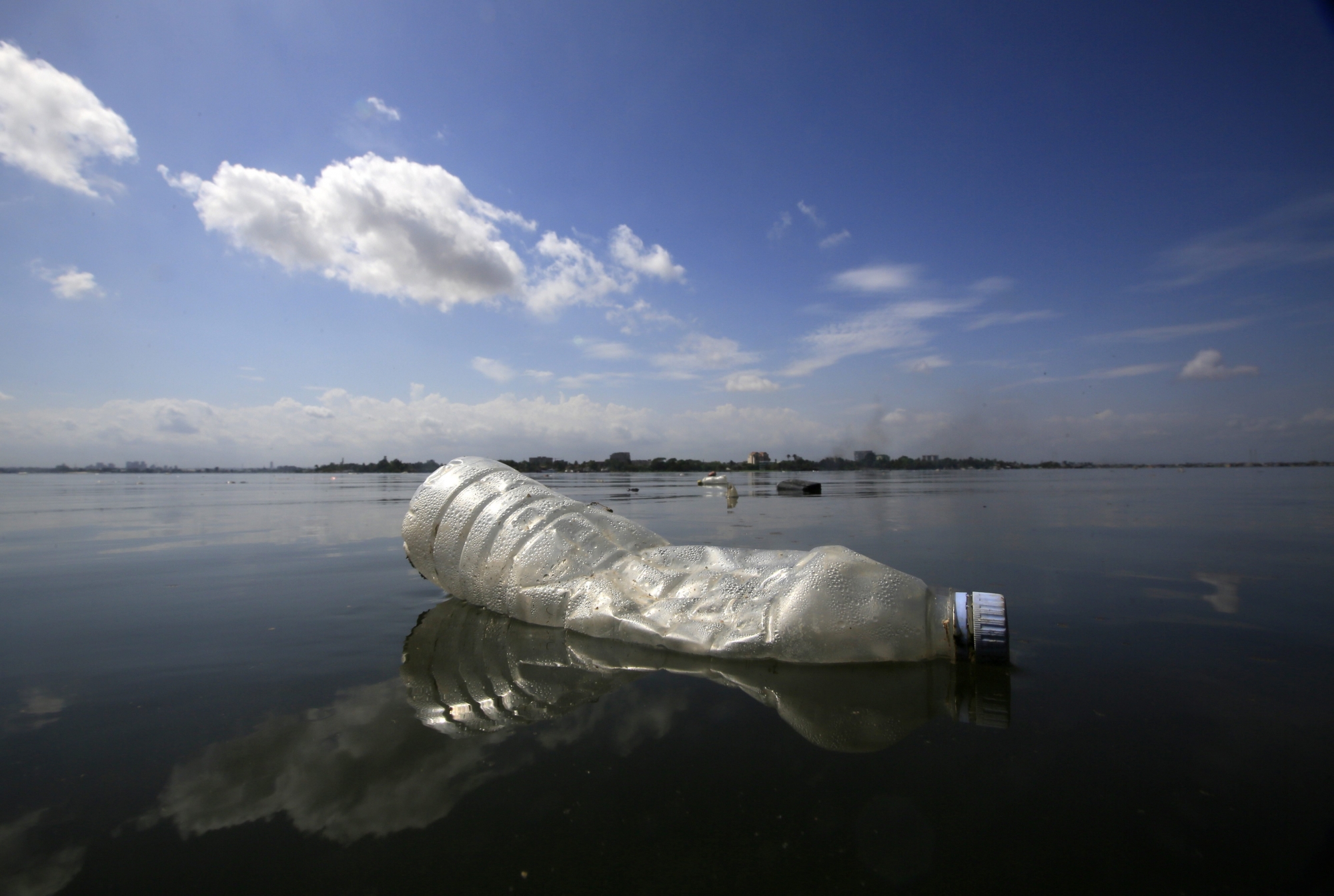 epa06777870 A plastic bottle floats on the Ebrie lagoon in the city of Abidjan, Ivory Coast, 28 May 2018. Plastic pollution has reached epidemic proportion. According to an Ellen MacArthur Foundation report there will be more plastic in the ocean than fish by 2050. Africa is one of the most affected continents due to its extensive coastline and underdeveloped waste systems allowing plastic waste to easily enter the ocean.  The rapid growth of plastic production in the three biggest areas the European Union, China and the US particularly in single-use plastics is recognised as one of the greatest risks facing the environment and mankind. Efforts at recycling and plastic waste education are on the rise on the African continent with many programs being initiated by youth groups who view the problem as the biggest environmental challenge facing the new generation.  EPA/LEGNAN KOULA  ATTENTION: This Image is part of a PHOTO SET Le Nouvelliste