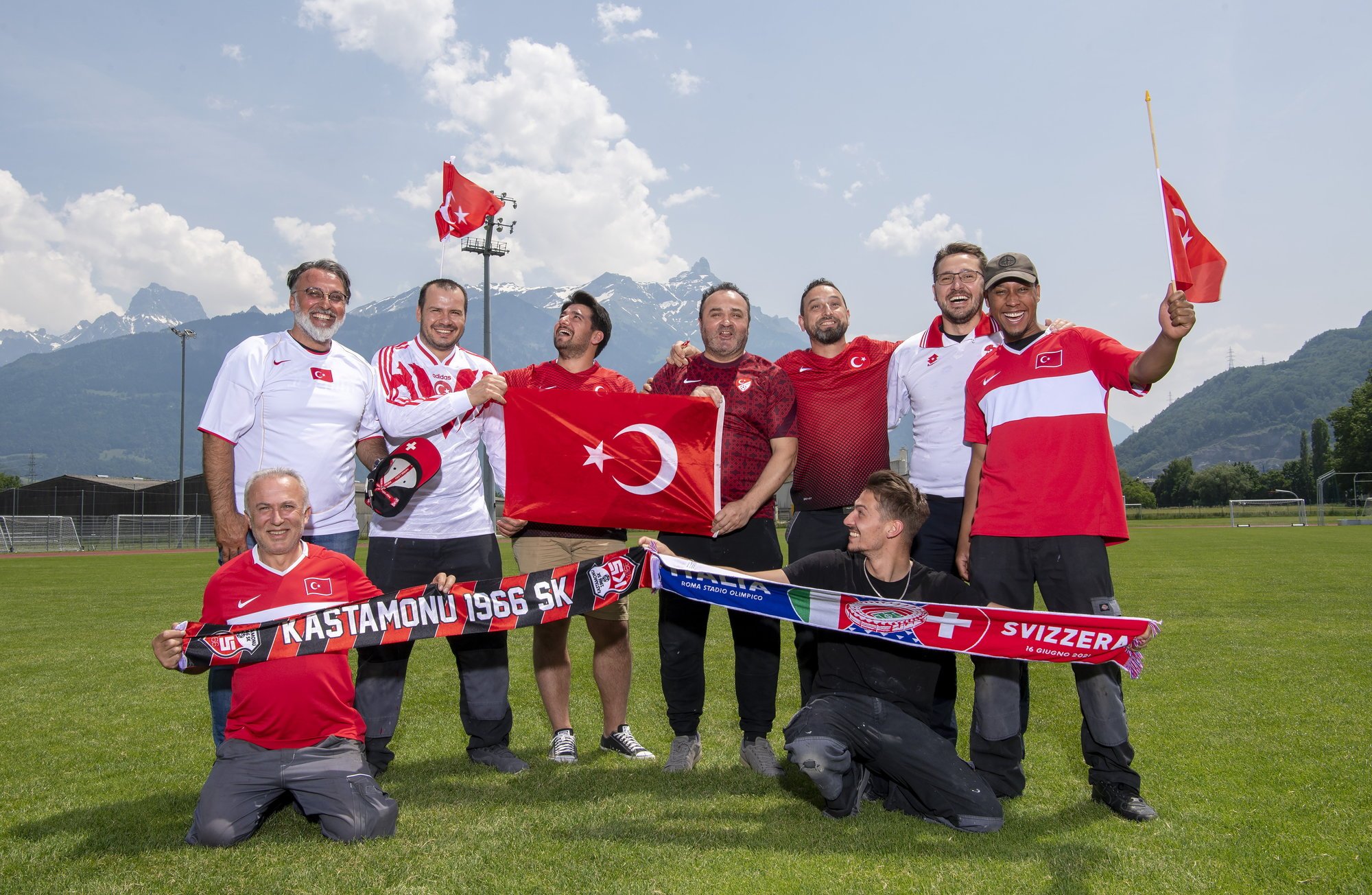 Les supporters turcs posent fièrement avec le maillot de leur équipe nationale sur la pelouse du Verney à Monthey malgré la déception des deux premiers matchs de leur équipe à l'Euro.