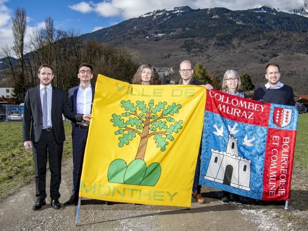 Les partisans de la fusion posent ici avec les deux drapeaux communaux.