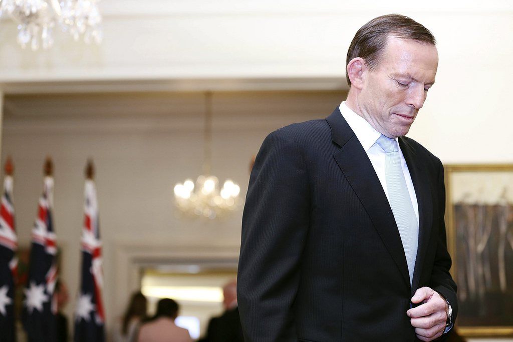 Tony Abbott pauses after being sworn in as the 28th prime minister of Australia at Government House in Canberra Wednesday, Sept. 18, 2013. Abbott promised immediate action to slow the stream of asylum seekers arriving by boats from Indonesia and to repeal an unpopular carbon tax levied by the previous administration. (AP Photo/Stefan Postles, Pool)