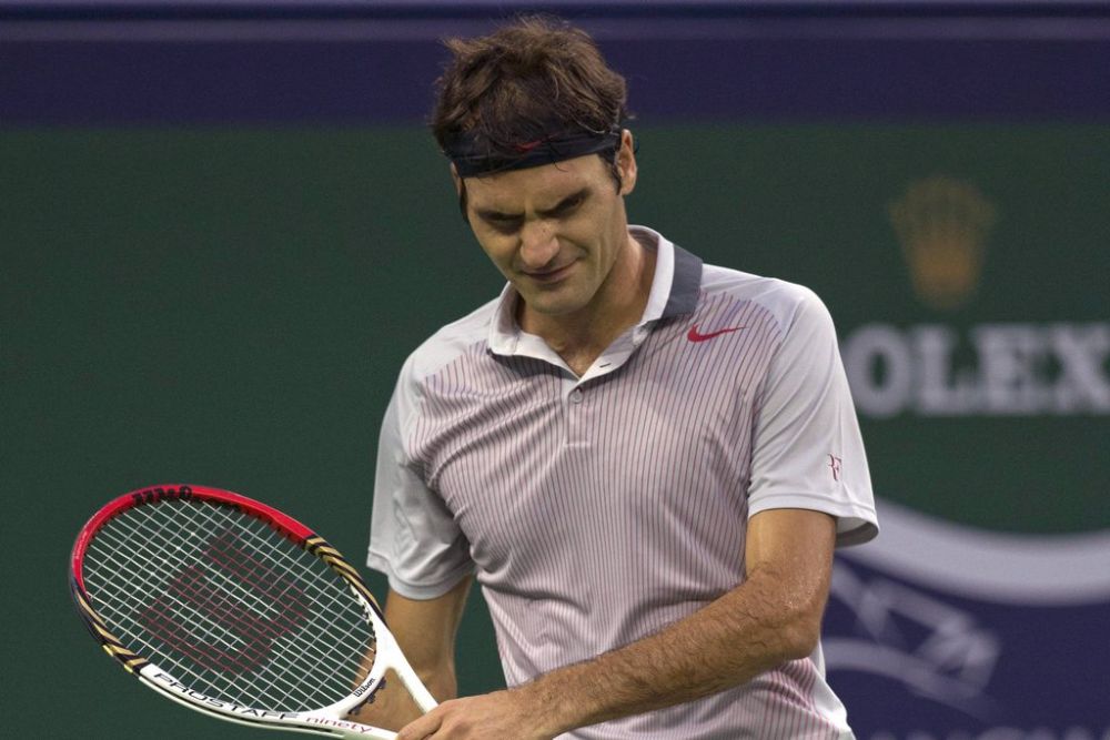 Switzerland?s Roger Federer reacts to losing a point during a match against France?s Gael Monfils at the Shanghai Masters tennis tournament at the Qizhong Forest Sports City Tennis Center in Shanghai, China, Thursday, Oct. 10, 2013. Monfils won 6-4, 6-7, 6-3. (AP Photo/Ng Han Guan)