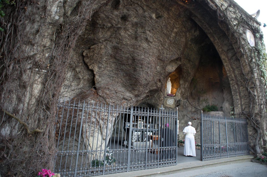 epa03627198 A handout picture made available by Vatican newspaper 'Osservatore Romano' on 16 March 2013 shows Pope Francis at the Lourdes grotto in the Vatican, 16 March 2013. Newly elected Pope Francis is set to deliver his first Angelus prayers 17 March and be inaugurated with a mass in Saint Peter's Square 19 March, which many world leaders are expected to attend, including Argentinian President Cristina Fernandez de Kirchner.  EPA/OSSERVATORE ROMANO / HANDOUT MANDATORY CREDIT HANDOUT EDITORIAL USE ONLY/NO SALES