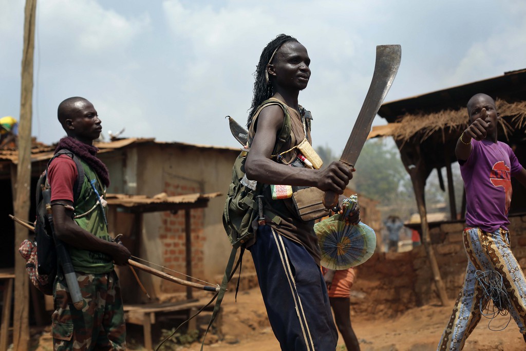 Anti-Balaka Christan youth loot the Muslim market in the PK13 district of Bangui, Central African Republic, Wednesday, Jan. 22, 2014. Hundreds of Anti-Balakas, helped by women and children, went on a rampage, burning and looting shops. Thirty civilian Muslims, trapped inside their home, were later rescued by French forces assisted by Rwandan African Union peacekeepers. (AP Photo/Jerome Delay)