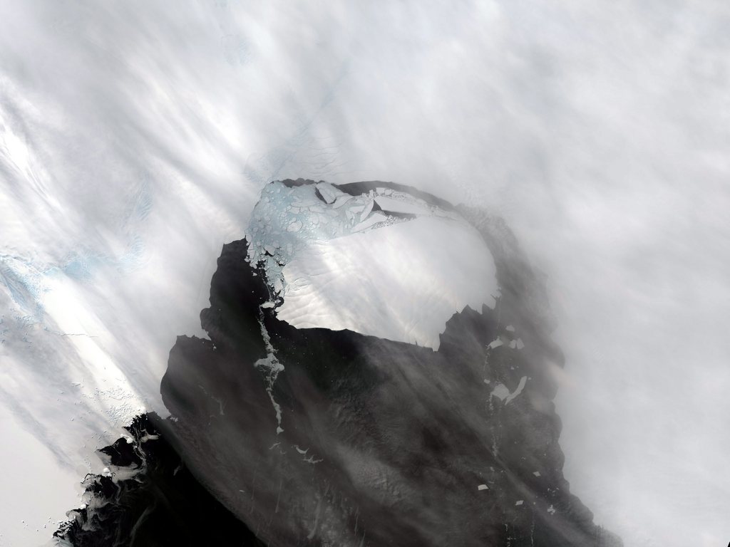 epa03956045 A handout picture made available by NASA on 19 November 2013 shows a giant iceberg, named B-31 by the US National Ice Center, estimated to be 35 km by 20 km or roughly the size of Singapore, taken on 13 November 2013 from the Landsat 8 satellite. B-31 in early November calved from Antarctica's Pine Island glacier (top) as the shelf of Pine Island Glacier has been moving forward at roughly four km per year. Such events happen about every five or six years, though Iceberg B-31 is about 50 percent larger than previous ones in this area. If Pine Island Bay clears of ice by the annual sea ice minimum in February???March, then Iceberg B-31 could move out into the Southern Ocean.  EPA/NASA  HANDOUT EDITORIAL USE ONLY