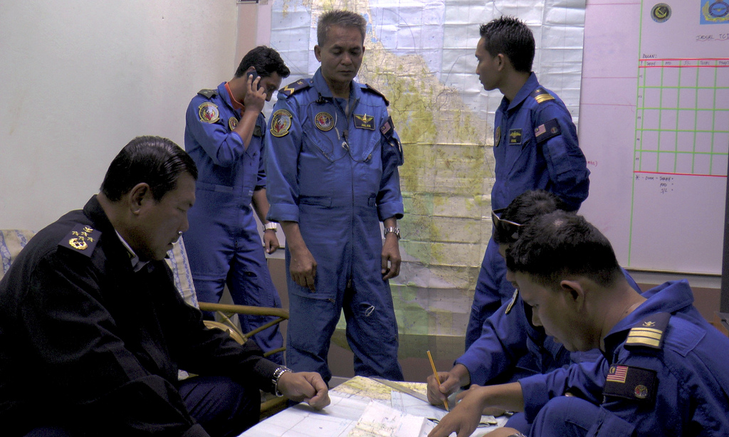 In this photo released by Malaysian Maritime Enforcement Agency, Director General of the Malaysian Maritime Enforcement Agency Admiral Mohd Amdan Kurish, left, briefs his officers before the start of searching for the missing Malaysia Airlines plane at Pasir Puteh in Kelantan, Malaysia, Sunday, March 9, 2014. Military radar indicates that the missing Boeing 777 jet may have turned back, Malaysia?s air force chief said Sunday as scores of ships and aircraft from across Asia resumed a hunt for the plane and its 239 passengers. (AP Photo/Malaysian Maritime Enforcement Agency)