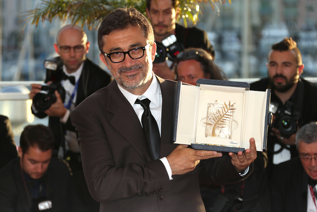 Director Nuri Bilge Ceylan poses with the Palme d'Or award for the film Winter Sleep during a photo call following the awards ceremony at the 67th international film festival, Cannes, southern France, Saturday, May 24, 2014. (Photo by Joel Ryan/Invision/AP)