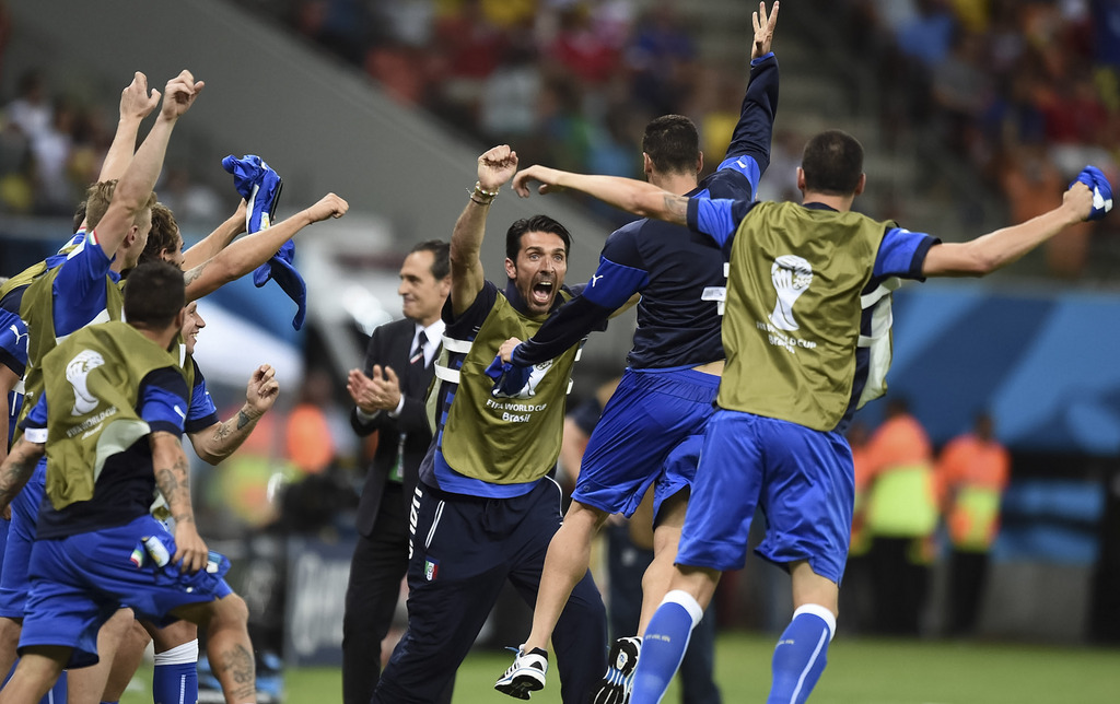 Italian goalie Gianluigi Buffon, face to camera, and coach Cesare Prandelli, center, celebrate with the team after the group D World Cup soccer match between England and Italy at the Arena da Amazonia in Manaus, Brazil, Saturday, June 14, 2014. Italy won the match 2-1. (AP Photo/Fabio Ferrari)