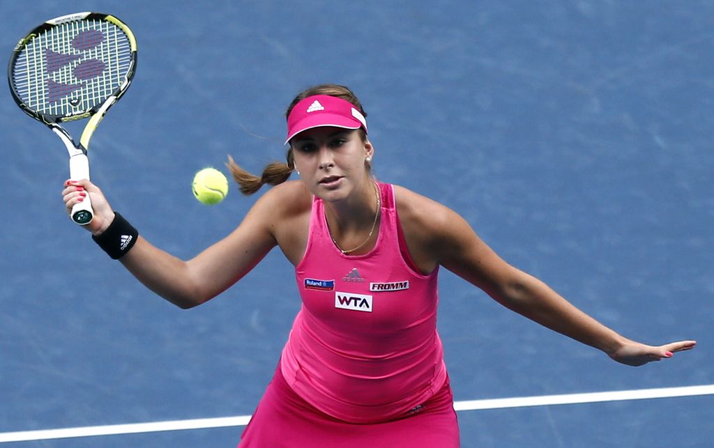 Belinda Bencic of Switzerland returns a shot to Lucie Safarova of the Czech Republic  during their second round match of the Japan Pan Pacific Open tennis tournament in Tokyo, Wednesday, Sept. 17, 2014. (AP Photo/Shizuo Kambayashi)