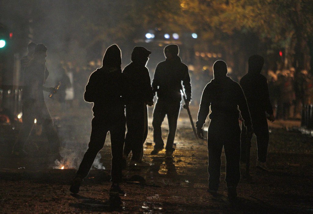 epa04518175 Protesters prepare to throw stones and molotov cocktail against policemen during clashes following a rally on the anniversary of the killing of teenager Alexis Grigoropoulos by a Greek police officer, in Athens, Greece, 06 December 2014. The protests are also in support of Nikos Romanos, a friend of Grigoropoulos who witnessed his death, who continues his hunger strike for the 27th consecutive day. Romanos, a 20-years-old anarchist convicted for armed robbery commited in 2013, began his protest after he was denied educational furlough to attend classes for a course at a Technological Educational Institute, where he had gained a place after sitting.  EPA/SIMELA PANTZARTZI