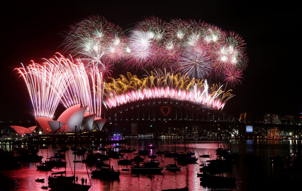 epa04543492 View of the 'Midnight Fireworks' above the Sydney Opera House (R) and the Sydney Harbour Bridge (L), seen from Mrs Macquarie's Point in Sydney, Australia, 01 January 2015.  EPA/NIKKI SHORT AUSTRALIA AND NEW ZEALAND OUT