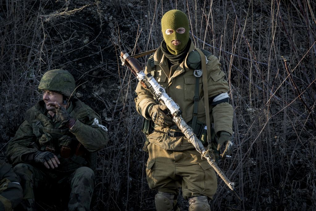 Russian-backed separatists wait for their transport, preparing to leave towards the frontline, in the village of Vergulivka, just outside Debaltseve, eastern Ukraine, on Friday, Feb. 13, 2015. Fierce fighting surged Friday in eastern Ukraine as Russian-backed separatists mounted a major, sustained offensive to capture a strategic railway hub ahead of a weekend cease-fire deadline. At least 25 people were killed across the region, officials reported. (AP Photo/Maximilian Clarke)