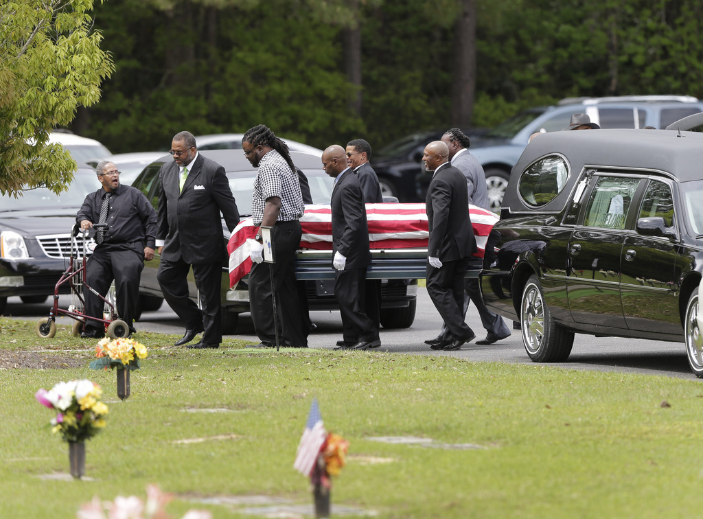 Pallbearers carry the casket of Walter Scott to his burial service in Charleston, S.C. on Saturday, April 11, 2015. Scott was fatally shot by a North Charleston, S.C., police officer a week earlier after a traffic stop. Officer Michael Slager has been charged with murder. (AP Photo/Chuck Burton)