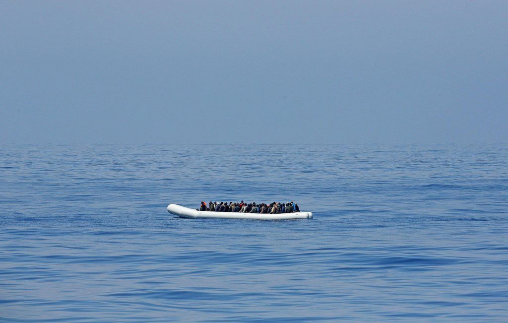 epa04717124 A picture made available on 23 April 2015 shows large number of illegal migrants on board a large dinghy-type vessel as they are rescued by the crew of the Italian Guardia di Finanza ship 'Denaro' in the Mediterranean Sea, 22 April 2015  EPA/ALESSANDRO DI MEO
