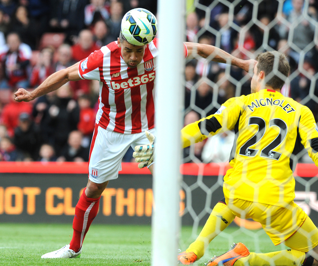 Stoke's Jonathan Walters heads the ball past Liverpool keeper Simon Mignolet to score against Liverpool during the English Premier League soccer match between Stoke City and Liverpool at the Britannia Stadium, Stoke on Trent, England, Sunday, May 24, 2015. (AP Photo/Rui Vieira)