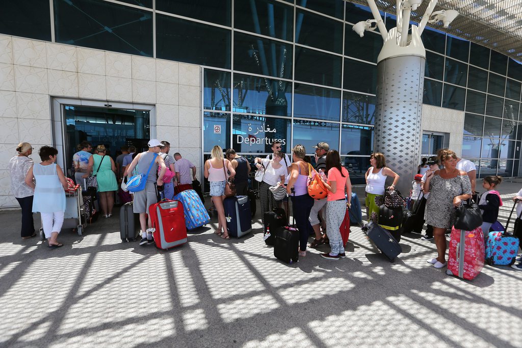 epa04821082 British tourists queue at the Enfidha international airport in Sousse, 27 June 2015. According to local reports 26 June, two assailants with handgrenades opened fire on tourists at two hotels, killing at least 37 people, including Germans, Brits and Belgians, and wounding several others, some while they were sunbathing, one of the attackers was killed by Tunisian security services, while a second has been arrested. The group affiliated with the so called Islamic State (IS) have claimed responsibility.  EPA/MOHAMED MESSARA