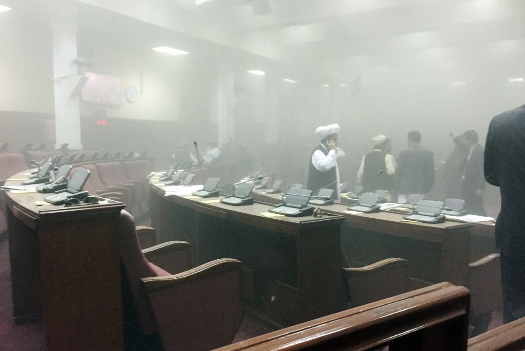 In this photo taken by Dr. Naqibullah Faiq, an Afghan member of parliament, lawmakers leave the main hall after a suicide attack in front of the main gate of Parliament, during clashes with Taliban fighters in Kabul, Afghanistan, Monday, June 22, 2015. The Taliban launched a complex attack, with a suicide car bomber striking at the entrance and gunmen battling police as lawmakers were meeting inside to confirm the appointment of a defense minister, police and witnesses said. (Dr. Naqibullah Faiq via AP) MANDATORY CREDIT