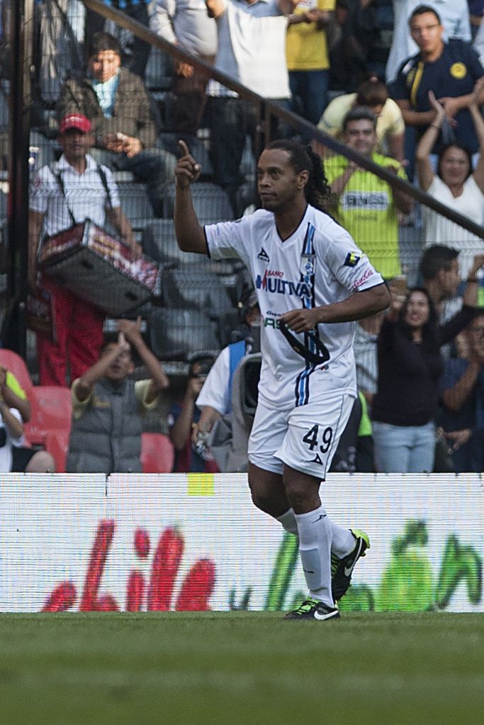 Queretaro's Ronaldinho celebrates after scoring against America during a Mexican soccer league match in Mexico City, Saturday, April 18, 2015. (AP Photo/Christian Palma)