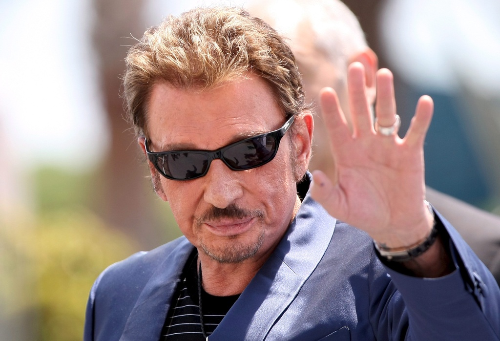 epa01962685 (FILE) A file photograph showing French musician Johnny Hallyday leaves the photocall for the Chinese film 'Vengeance' by Johnnie To running in competition in the 62nd edition of the Cannes film festival in Cannes, France, 17 May 2009. French rock and roll singer Johnny Hallyday aged 66 is reportedly in an induced coma at Cedars-Sinai Hospital in Los Angeles, California, USA, on 12 December 2009 after being admitted due to complications from back surgery in Paris in November 2009.  EPA/IAN LANGSDON