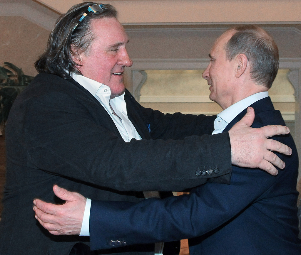French actor Gerard Depardieu, left, greets Russian President Vladimir Putin after his arrival late Saturday, Jan. 5, 2013, at the president's residence in Sochi, the host city of the 2014 Winter Olympics. Depardieu has received a Russian passport after flying to Russia for a late night dinner with Putin. Depardieu sought Russian citizenship as part of his battle against a proposed super tax on millionaires in France, and Putin granted his request last week. (AP Photo/RIA-Novosti, Mikhail Klimentyev, Presidential Press Service)