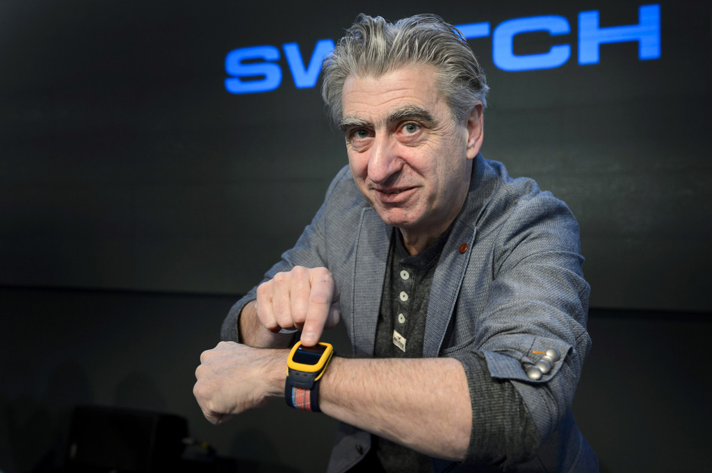 CEO of Swatch Group Nick Hayek poses with a watch "Swatch Touch Zero One", after a press conference of the year 2014 final results of Swiss watch company Swatch Group, in Corgemont, Switzerland, Thursday, March 12,  2015. (KEYSTONE/Laurent Gillieron)