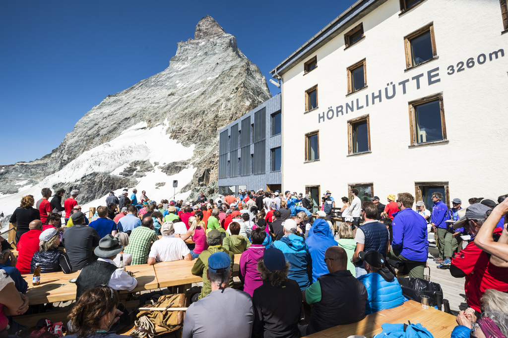 Guests during the official inauguration on the terrace of Hoernli hut in front of the Matterhorn mountain, Switzerland, Tuesday, July 14, 2015. On the 14th of July, Zermatt celebrates 150 years since the first ascent of the Matterhorn mountain. On July 14, 1865, the british climber Edward Whymper reached the peak of the Matterhorn (4,478 metres above sea level) together with his rope team. (KEYSTONE/Dominic Steinmann)