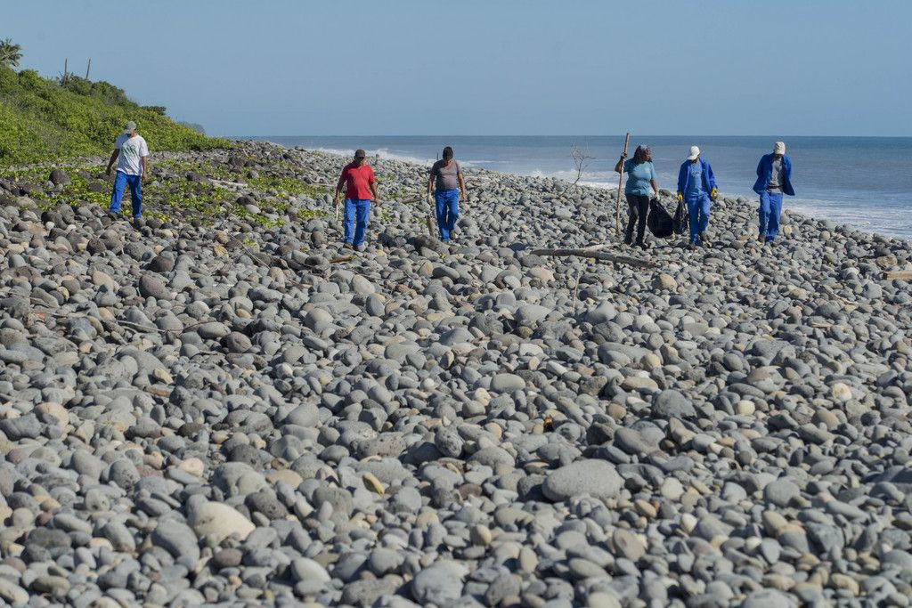 Municipal workers search Reunion Island beaches where expected debris of the missing Malaysia Airlines Flight 370 could be washed up onto the shore near Saint-Andre, on the French Island of Reunion,  Monday Aug. 10, 2015. Malaysia Airlines Flight 370 disappeared on 8 March 2014, while flying from Kuala Lumpur, Malaysia to Beijing, China. (AP Photo/Fabrice Wislez)