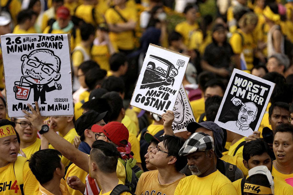 epa04903445 Placards depicting Malaysian Prime Minister Najib Razak held up by Malaysian protestors marching during a BERSIH (The Coalition for Free and Fair Elections) rally in Kuala Lumpur, Malaysia, 29 August 2015. Bersih 4.0 planned as the fourth large rally held in three Malaysian cities on 29 and 30 August, to push for Prime Minister Najib Razak's resignation as well as institutional reforms to prevent prime ministerial corruption. The rally comes amid allegations that some 700 million US dollar (622 million euro) was deposited into Najib's personal bank accounts and alleged mismanagement of debt-ridden state investor 1Malaysia Development Berhad (1MDB).  EPA/RITCHIE B.TONGO