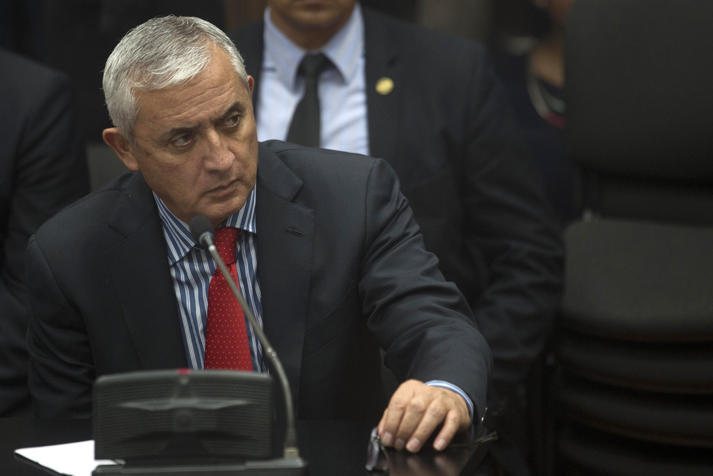 Guatemala's former President Otto Perez Molina listens to judge Miguel Angel Galvez in court where he faces corruption charges, after he submitted his resignation in Guatemala City, Thursday, Sept. 3, 2015. The president submitted his resignation at midnight local time late Wednesday after a judge issued an order to detain him in a corruption scandal. Perez Molina was already under order not to leave the country, and on Tuesday the congress lifted his immunity from prosecution. His resignation is not effective until members of Congress accept it and name a new president, which is expected to happen Thursday. (AP Photo/Moises Castillo)
