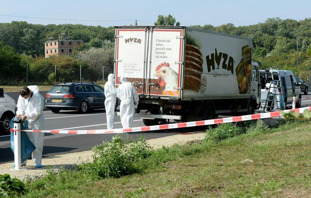 epa04900497 Forensic experts investigate a truck in which refugees were found dead as it stands on freeway autobahn A4 between Parndorf and Neusiedl, Austria, 27 August 2015. According to reports, some 50 refugees were found dead in the lorry parked at the autobahn. It cannot be confirmed if the dead suffocated in the truck, as some media have reported. The lorry was discovered by highway workers who called police. The driver has disappeared, according to media reports.  EPA/ROLAND SCHLAGER