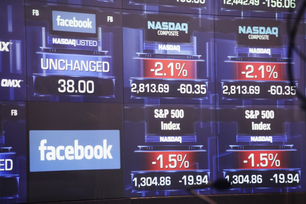 Electronic screens inside the Nasdaq stock market announce the listing of Facebook shares before the start of trading, Friday, May 18, 2012 in New York. The world's definitive online social network raised $16 billion in an initial public offering that values the company at $104 billion. (AP Photo/Mark Lennihan)