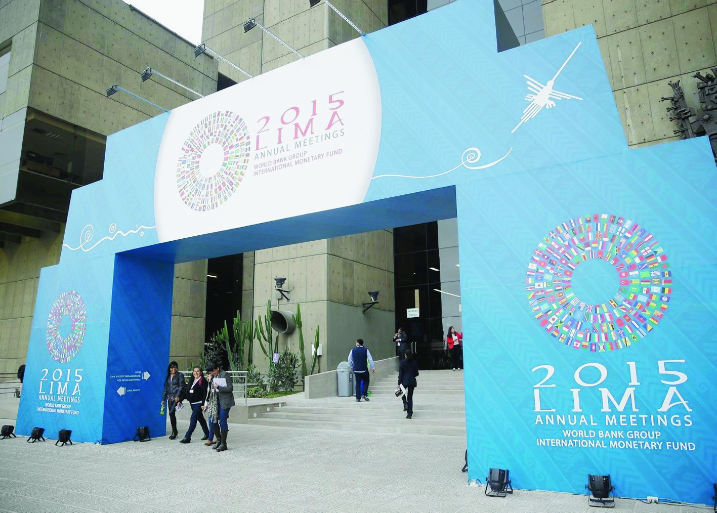 People pass under a welcome sign for the IMF and World Bank annual meetings in Lima, Peru, Tuesday, Oct. 6, 2015. The meetings are taking place Oct. 6-11. (AP Photo/Martin Mejia) Peru World Bank
