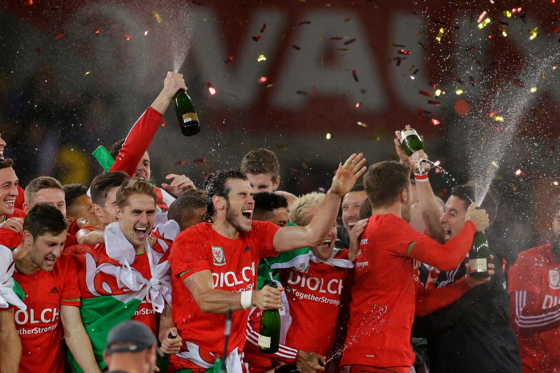 Wales' Gareth Bale, center, celebrates with his teammates after they qualified for the Euro 2016 tournament after defeating Andorra 2-0 in the Euro 2016 Group B soccer match between Wales and Andorra at Cardiff City stadium in Cardiff, Tuesday, Oct. 13, 2015.  (AP Photo/Matt Dunham) Britain Wales Andorra Euro Soccer