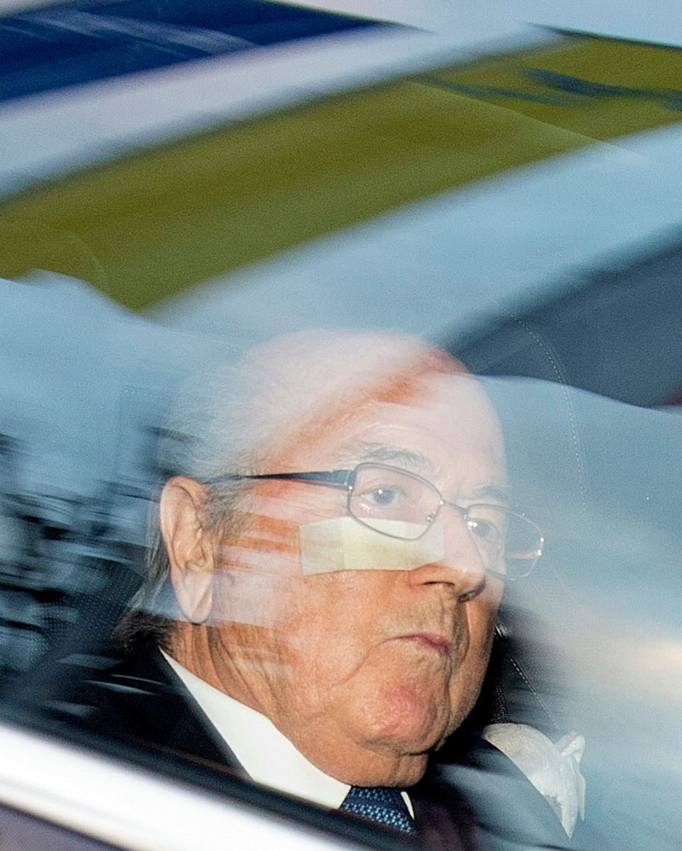 FIFA President Sepp Blatter, left, and his lawyer Lorenz Erni, right, arrive in a car at the FIFA headquarters "Home of FIFA" in Zurich, Switzerland, Thursday morning, Dec. 17, 2015. While FIFA President Joseph S. Blatter will appear in person on Thursday before the panel of four judges of the FIFA ethics court, UEFA President Michel Platini plans to boycott his hearing on Friday 18 December. Blatter and Platini were banned for 90 days for all activities in football.  (Walter Bieri/Keystone via AP) APTOPIX Switzerland Soccer FIFA Blatter