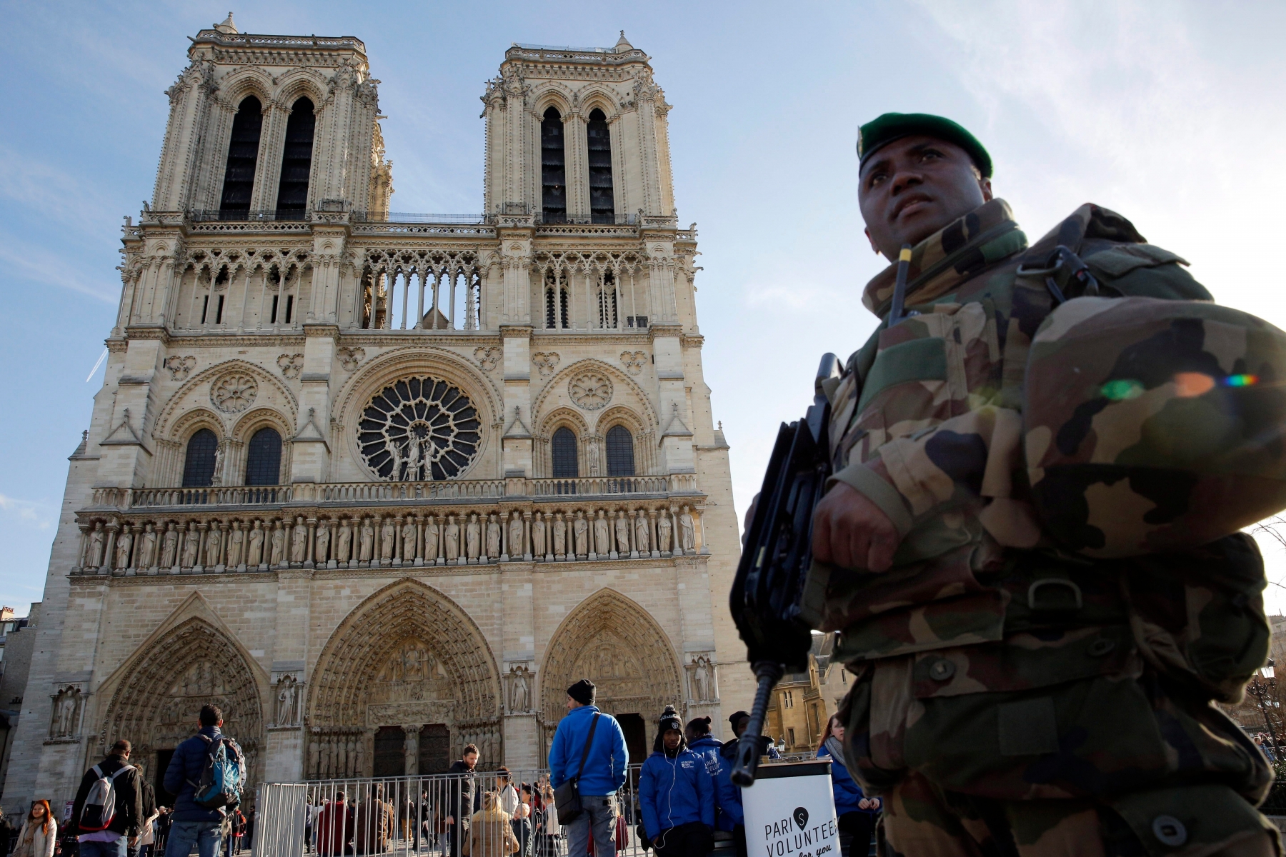 A soldier patrols in front of Notre Dame cathedral, in Paris, Wednesday, Dec. 23, 2015. France's interior minister says the government will tighten security for churches around Christmas, amid continued concerns about potential extremist violence after deadly attacks last month. (AP Photo/Christophe Ena) France Holiday Security