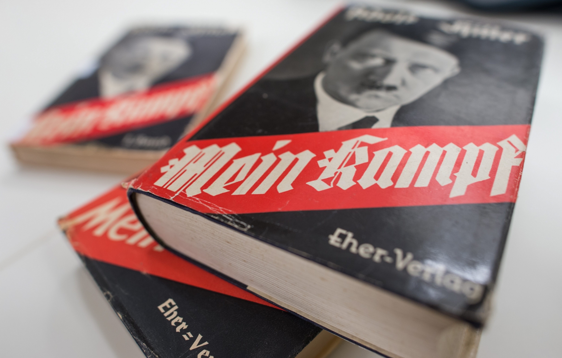 FILE - In this  Dec. 11, 2015, file photo, different editions of Adolf Hitler's "Mein Kampf" are on display at the Institute for Contemporary History in Munich. For 70 years since the Nazi defeat in World War II, copyright law has been used to prohibit the publication of Mein Kampf, the notorious anti-Semitic tome in which Hitler set out his ideology, in Germany. That will change in January 2016, when a new edition with critical commentary, the product of several years' work by a publicly funded institute, hits the shelves. While historians say it could help fill a gap in Germans' knowledge of the era, Jewish groups are wary. (Matthias Balk/dpa via AP) Germany Mein Kampf