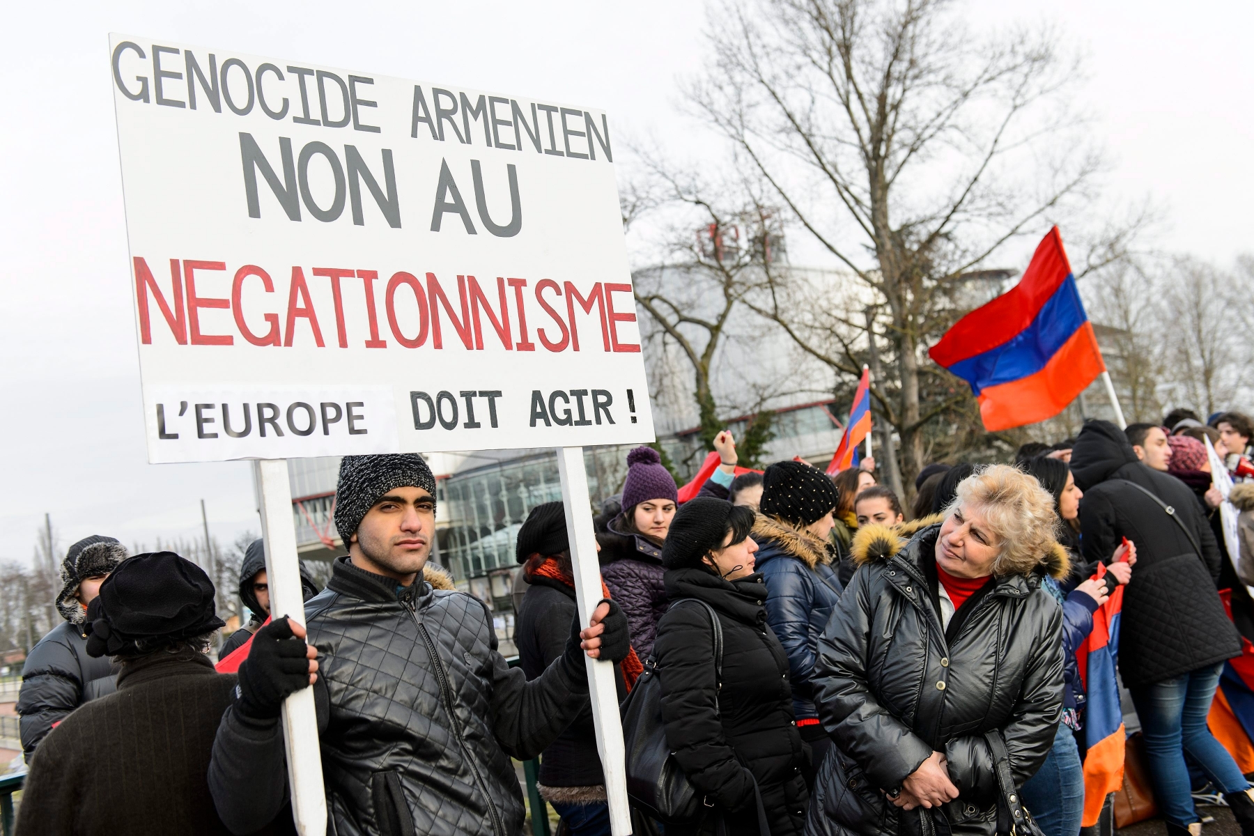 Armenian supporters hold banners during the hearing in the case Perincek vs Switzerland, at the European Court of Human Rights (ECHR) in Strasbourg, France, Wednesday, January 28, 2015. The European Court of Human Rights holds a Grand Chamber Hearing in the case between turkish political activist Dogu Perincek and Switzerland concerning freedom of expression. Perincek was convicted by a Swiss court following comments denying the Armenian Genocide during a visit in Switzerland 2007. (KEYSTONE/Jean-Christophe Bott) FRANCE SWITZERLAND ECHR PERINCEK