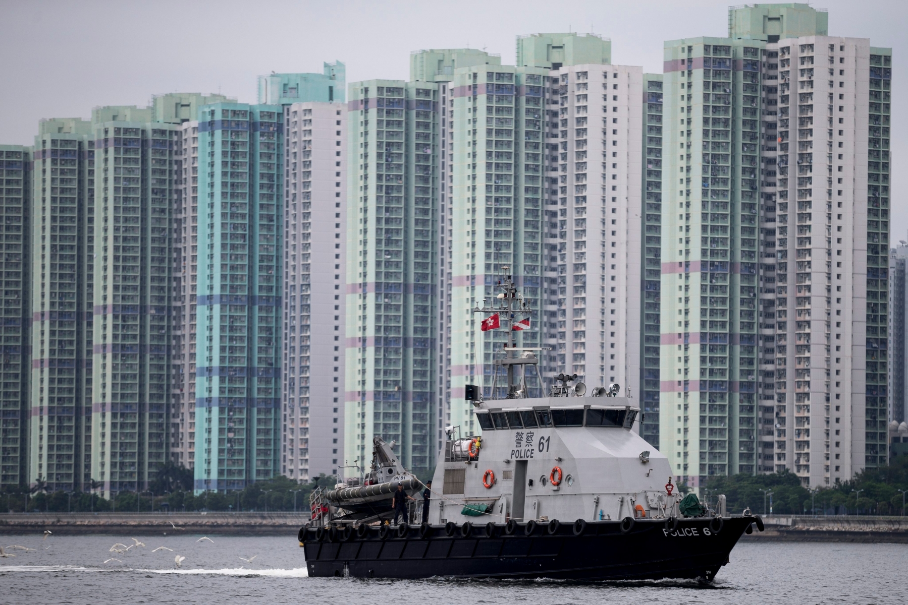 epa05313626 A police boat patrols Tolo Harbour near Hong Kong Science Park where Zhang Dejiang, chairman of the Standing Committee of the National People's Congress, is visiting in Hong Kong, China, 18 May 2016. Reports says about 8,000 officers are being deployed to maintain security during the most eventful day of state leader Zhang's visit.  EPA/JEROME FAVRE CHINA HONG KONG POLICE