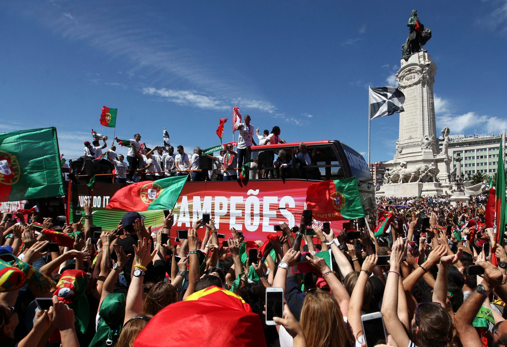 epa05420772 Portugal national soccer team supporters waving Portuguese flags and scarfs at Marquis of Pombal square as the Portuguese Team crosses Lisbon downtown, Portugal, 11 July 2016. The Portugal national soccer team on 10 July 2016 had won the UEFA Euro 2016 final against France by 1-0 to win the title for first time.  EPA/NUNO VEIGA PORTUGAL SOCCER UEFA EURO 2016