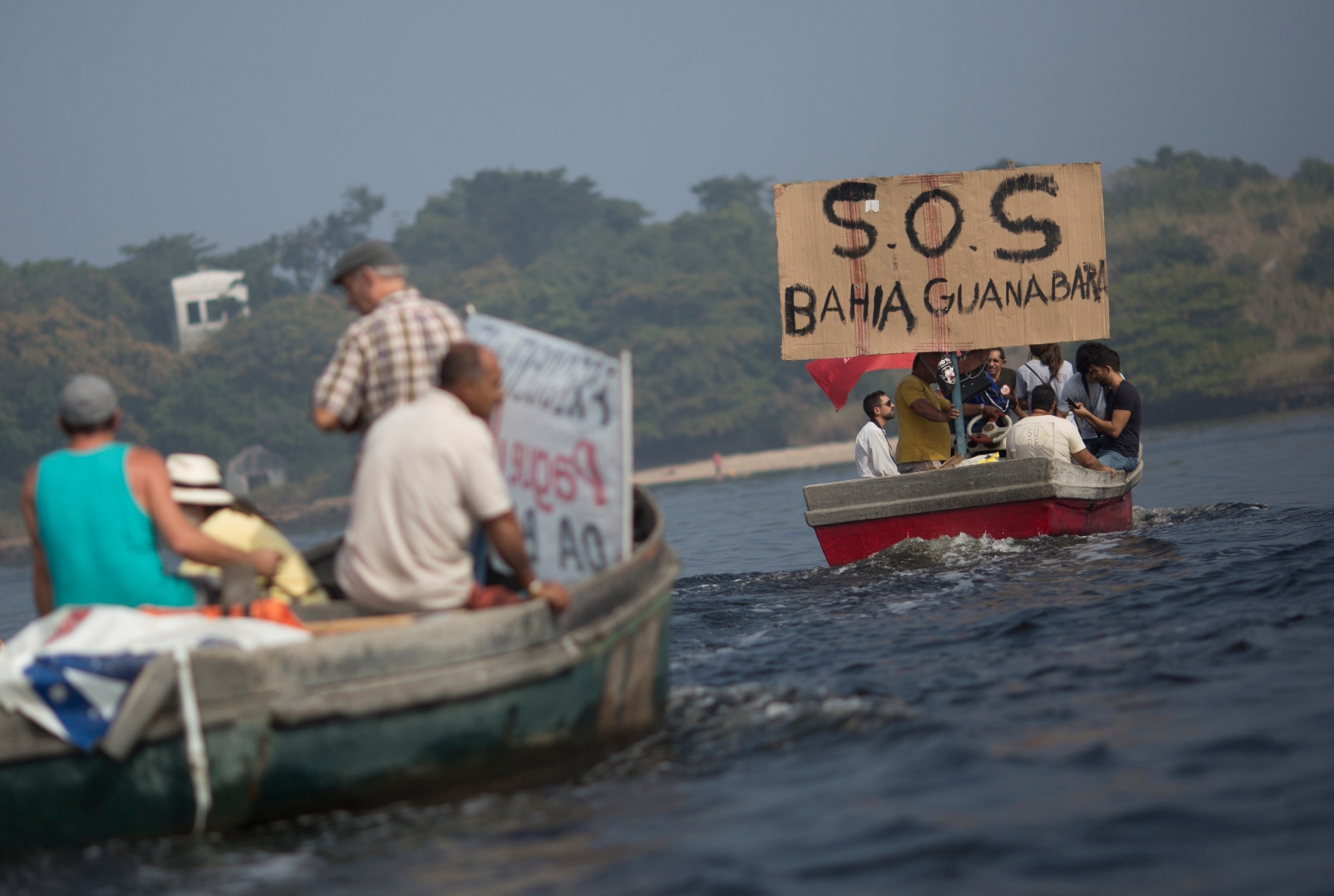 In this Sunday, July 3, 2016 photo, fishermen protest the pollution in the Guanabara bay, in Rio de Janeiro, Brazil. Rio state officials have acknowledged a real cleanup of Guanabara will take 20 years after organizers promised to do it for the Olympics, with the city still pouring at least half of its untreated sewage into its surrounding waters, including Guanabara. (AP Photo/Silvia Izquierdo) The Week That Was from Latin America Photo Gallery