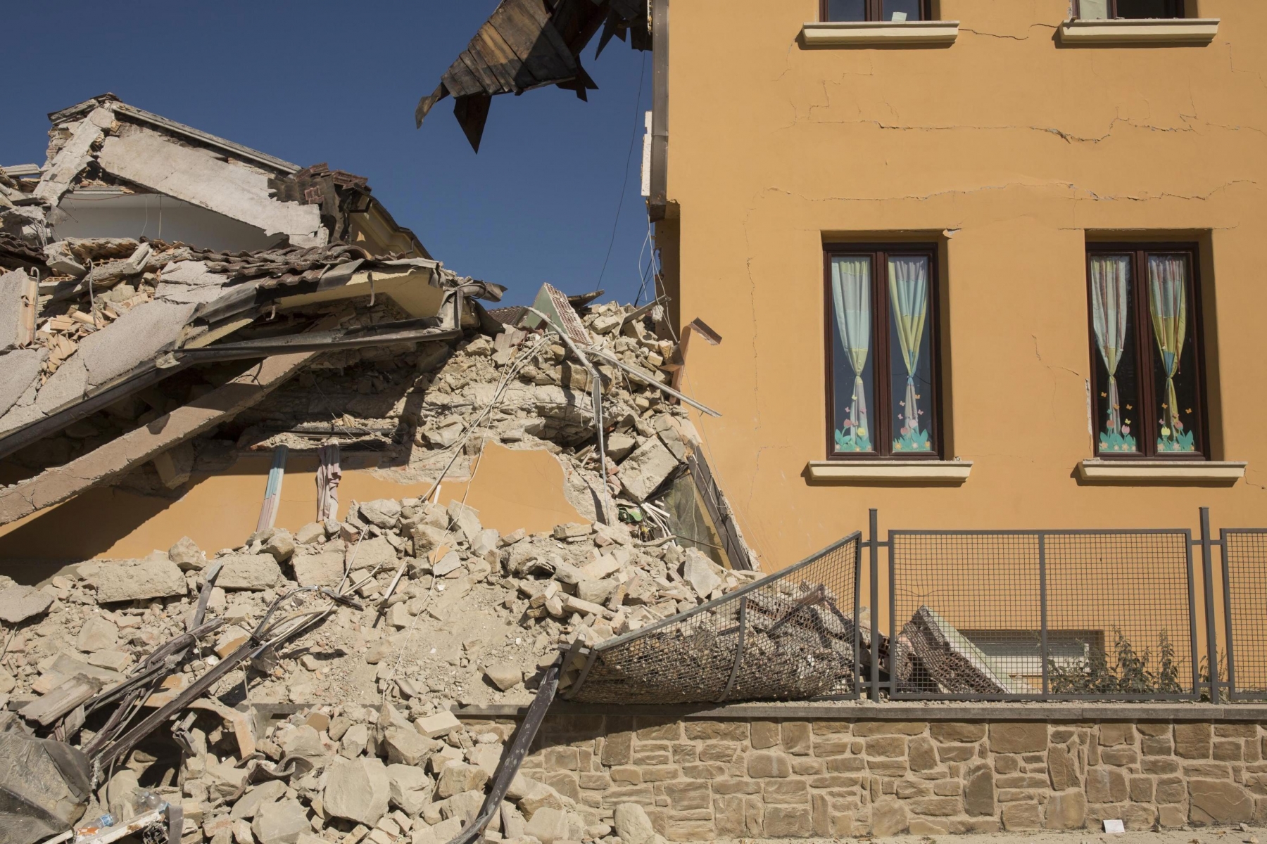 epa05513207 The Romolo Capranica school, partially collapsed after the 24 August devastating earthquake, in the Lazio mountain village of Amatrice, central Italy, 28 August 2016. The Civil Protection Department said on 28 August that the latest provisional death toll from the earthquake in central Italy is 291.  EPA/ROBERTO SALOMONE ITALY EARTHQUAKE AFTERMATH