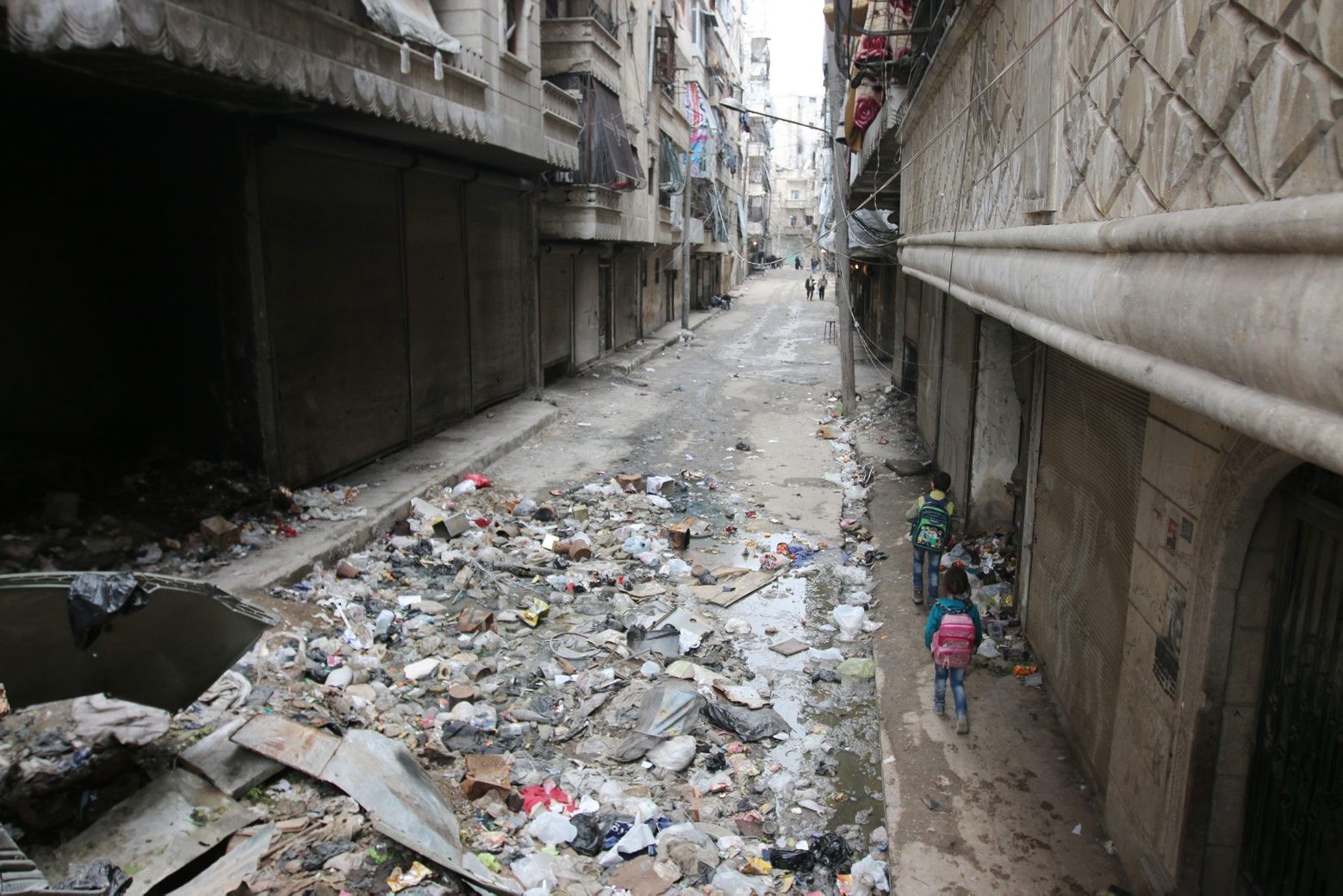 In this Thursday, Feb. 11, 2016 photo, children walk down a street in Aleppo, Syria. The fighting around Syria's largest city of Aleppo has brought government forces closer to the Turkish border than at any point in recent years, routing rebels from key areas and creating a humanitarian disaster as tens of thousands of people flee. (Alexander Kots/Komsomolskaya Pravda via AP) Mideast Syria