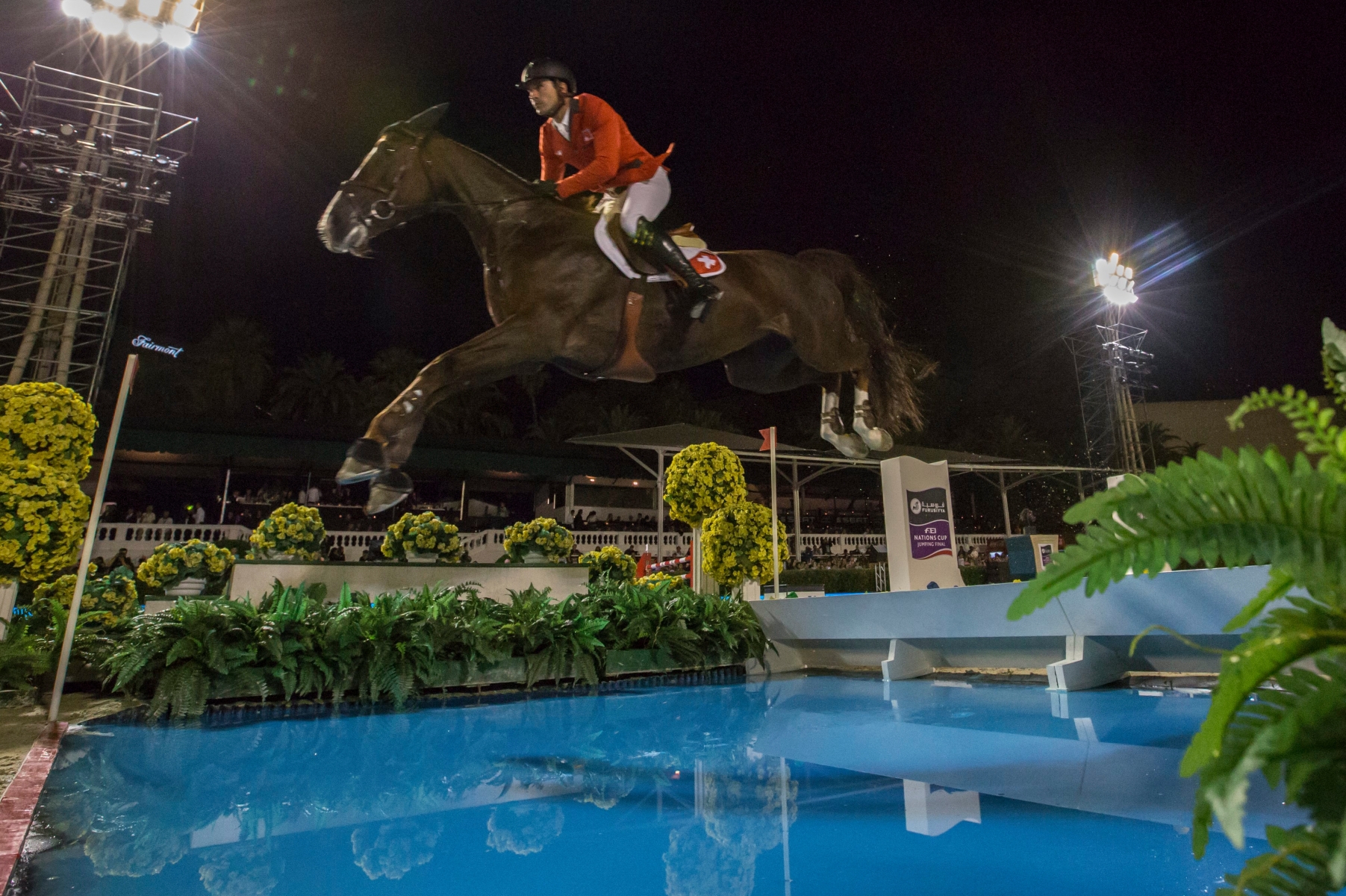 epa05555007 Romain Duguet of Switzerland rides Quorida de Treho over a water jump during the Furusiyya FEI Nations Cup Jumping Final 2016 in Barcelona, Spain, 24 September 2016.  EPA/JIM HOLLANDER SPAIN EQUESTRIAN NATIONS CUP