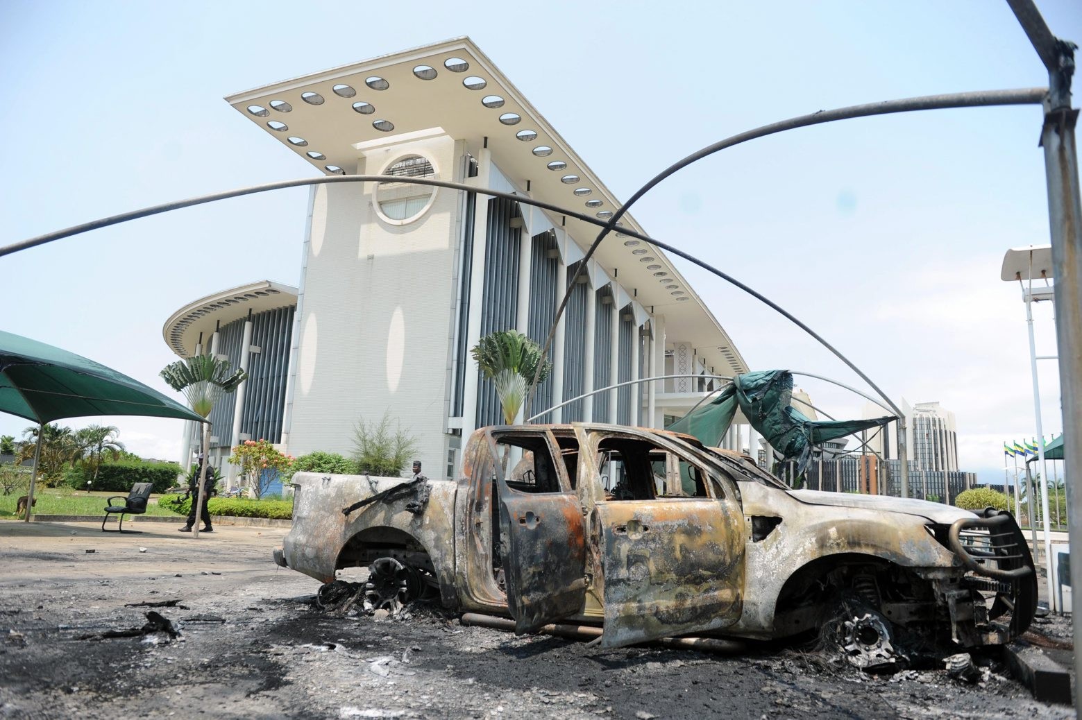 A burned vehicle sits outside a government building after an election protest in Libreville, Gabon, Thursday Sept. 1, 2016. Gabon's newly re-elected president sought to assert authority Thursday as the presidential guard attacked the opposition candidate's party headquarters overnight, killing at least one person and injuring more than a dozen amid fiery protests that have seen hundreds detained and the internet blocked. (AP Photo/Joel Bouopda) Pictures Of The Week Photo Gallery